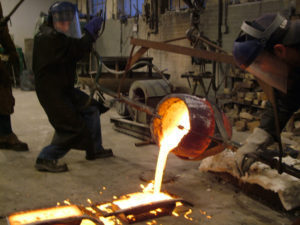 Maressa pouring bronze at a bronze foundry